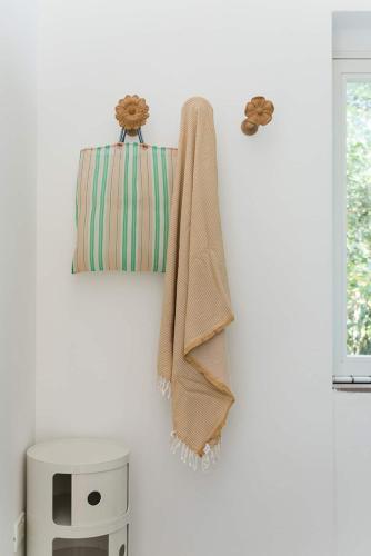 a towel hanging on a wall next to a window at Casottino presso residenza Rosso di Sera in Capoliveri