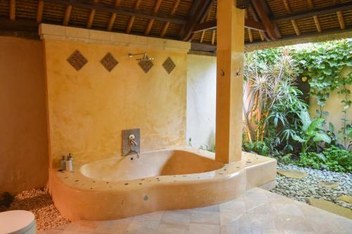 a bath tub in the middle of a house at Villa Layangan - Two Bedrooms with Pool Access in Sanur