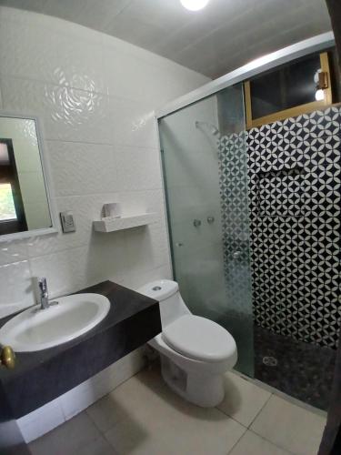 a bathroom with a toilet and a sink and a shower at Hotel Santa María in Mazatlán