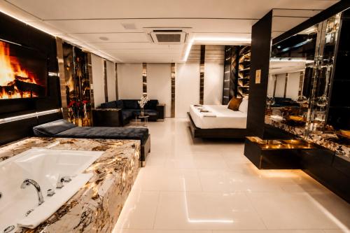 a large bathroom with a tub and a living room at 1Million Suites in Medellín