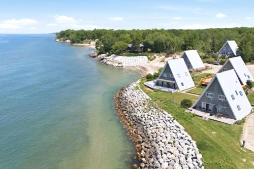 an aerial view of a house on the shore of the water at Chalet #18 in Stevensville
