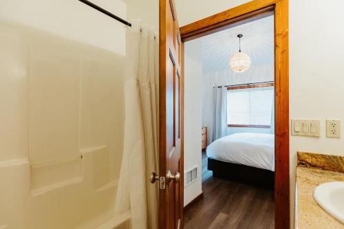 a bathroom with a bed and a shower and a sink at Mt Stimson Suite Work-From-Anywhere-Ready in Kalispell