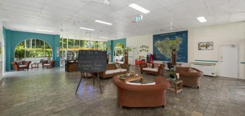 a waiting room with couches and chairs in a hospital at 71 Mandalay in Nelly Bay