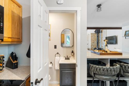 a bathroom with a sink and a mirror at Ski-OnSki-Off Camelback Arcade Pool in Tannersville