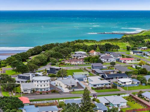 an aerial view of a town with the ocean at Headlands Hotel in Opunake