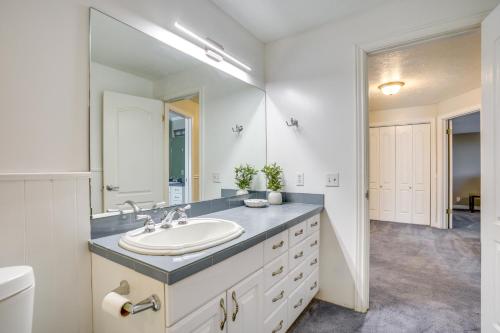 a bathroom with a sink and a large mirror at Easy AFB Commute! Clearfield Unit w/ Private Patio in Clearfield