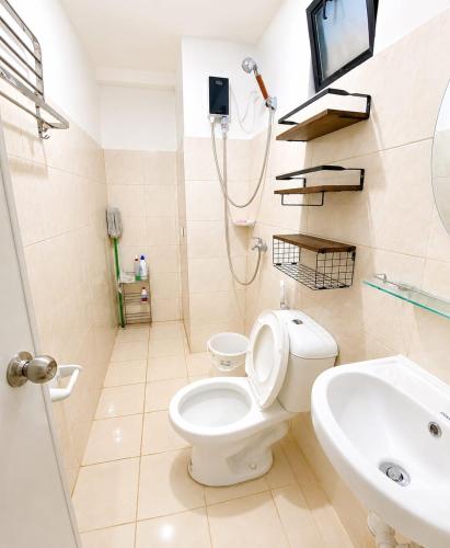 a bathroom with a toilet and a sink at DG Coastal Comfort near Alona Beach - Pool, Gym and Play area in Dauis