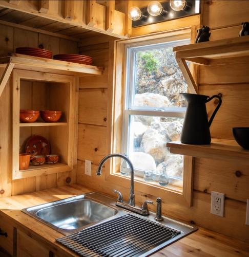 a kitchen with a sink and a window at Peaceful Forest Tiny Home in Newport