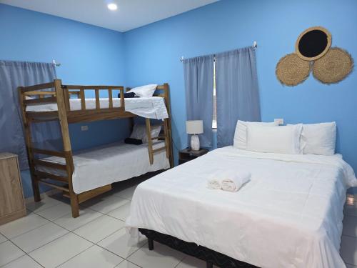 a bedroom with a bed and a bunk bed at Lodge Ayla Punta Mango in Jucuarán