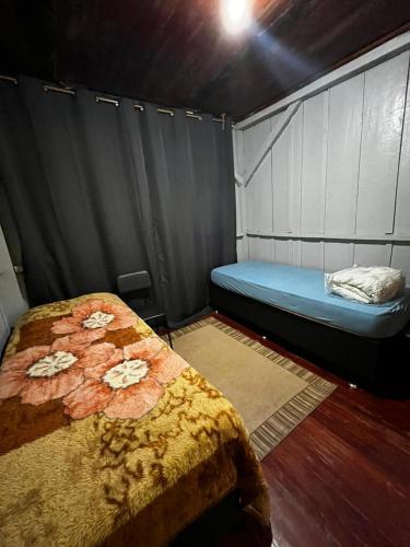 a bedroom with a bed in a room with a wall at Casa proximo parque in Santa Rosa