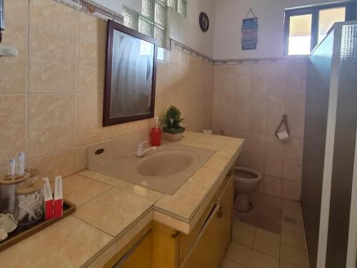 a bathroom with a sink and a toilet at Danao RM House in Idanao