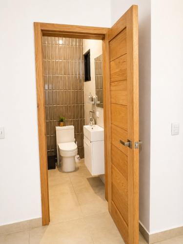 a bathroom with a toilet and a sink at Modern Villa 2 BR Near Airport, Beaches, Dining in Punta Cana