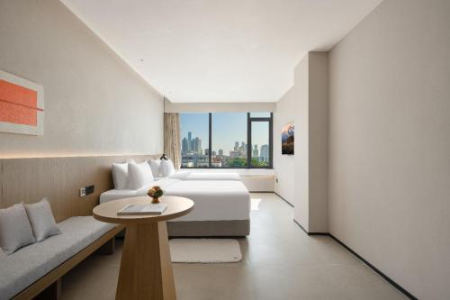 a hotel room with a bed and a table at SOVIS PLUS HOTEL in Shenzhen