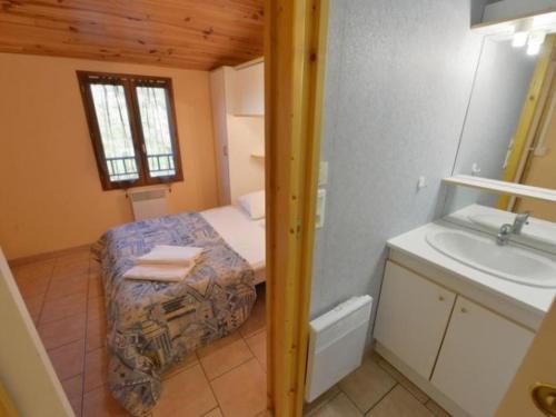 a small bathroom with a bed and a sink at Maison avec animaux admis - 4 pers. - API-1-52-2864 in Saint-Rome-de-Tarn