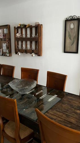 a dining room with a glass table and chairs at Mírame Canarias in Vecindario