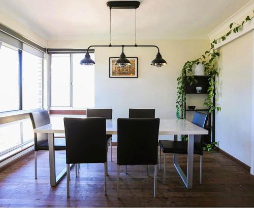 a dining room with a table and chairs at Smugglers Cove in Esperance