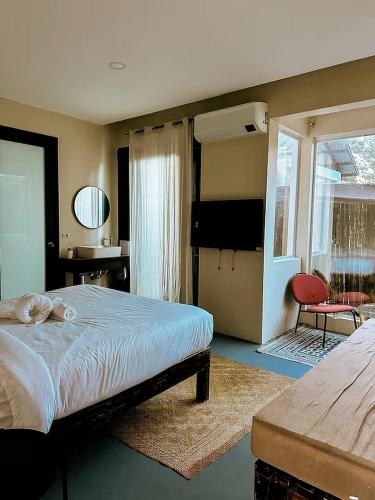 a bedroom with a bed and a television in it at The Ronin in General Luna