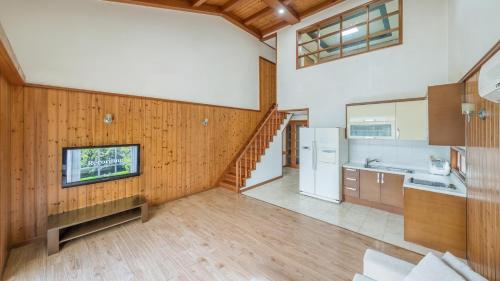 a large kitchen with a staircase in a house at Daebu-do, White Island Pension in Ansan