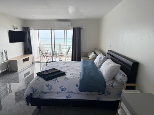 a bedroom with a bed and a view of the ocean at New world condo1802 in Rayong