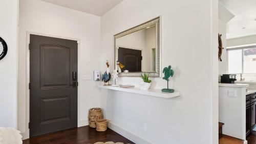 a hallway with a mirror and a door at Stimson Coastal Luxury by AvantStay in Pismo Beach