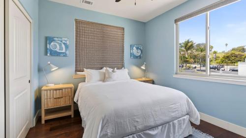 a blue bedroom with a bed and a window at Stimson Coastal Luxury by AvantStay in Pismo Beach