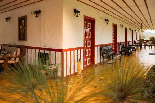 a building with a lobby with tables and chairs at San Remo Ecolodge in Santa Rosa de Cabal