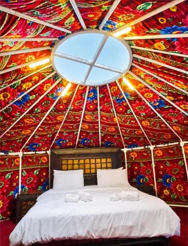 a room with a bed in a yurt with a mirror at Escape Retreat Hunza in Karimabad Hunza