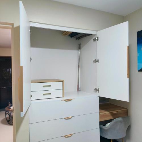 a white closet with white cabinets and a desk at Villa Bosque - Forest Residences in Antipolo