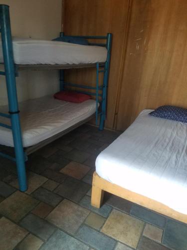 two bunk beds in a room with a tiled floor at hostal la playa vallarta in Puerto Vallarta