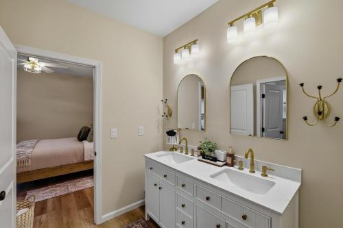 a bathroom with a sink and two mirrors at The Four Seasons Escape in Pocono Lake