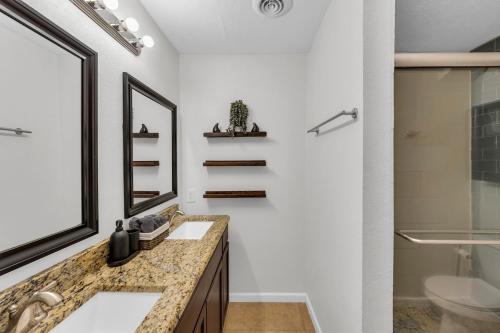 a bathroom with two sinks and a shower at FIFA World Cup Backyard Retreat in Dallas