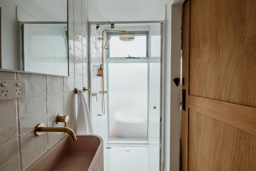 a bathroom with a sink and a mirror at The Floathouse - Floating tiny home on the Murray in White Sands