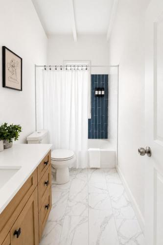 a white bathroom with a toilet and a shower at The View at Green Cay - Full AC - Walk to the Beach in Christiansted