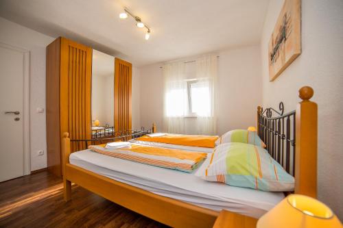 Posteľ alebo postele v izbe v ubytovaní Apartments Kati