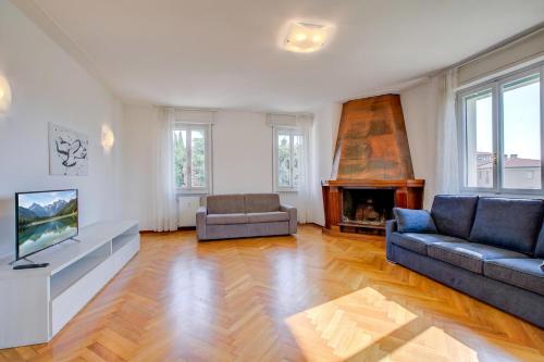 a living room with a couch and a fireplace at Margherita near lake - Family Friendly - Happy Rentals in Toscolano Maderno