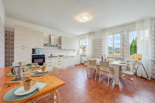 a kitchen and dining room with a table and chairs at Margherita near lake - Family Friendly - Happy Rentals in Toscolano Maderno