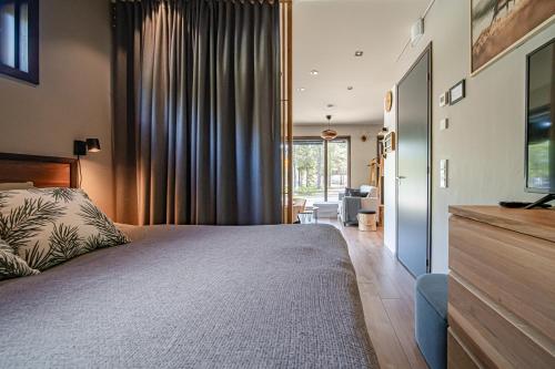 a bedroom with a large bed and a living room at Levi Platinum Aurora in Levi