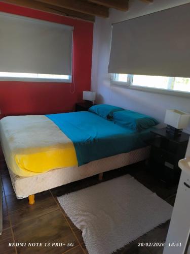 a bedroom with a bed and a window at Alojamiento Amado in Los Antiguos