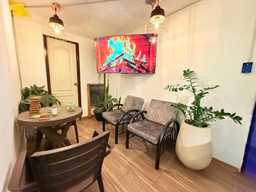a dining room with a table and chairs at Bababuy Hostel in Bogotá
