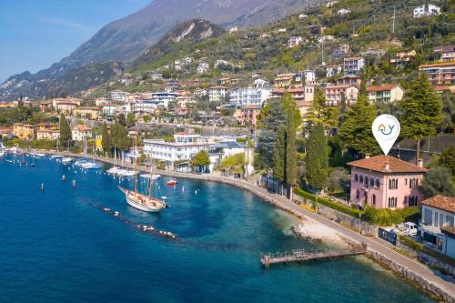 an aerial view of a town with a boat in the water at Villa Schlosser Lake Front & Private Pool in Malcesine