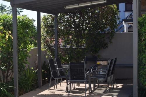 a table and chairs sitting under a pergola at Gladstone Heights Executive Apartments in Gladstone