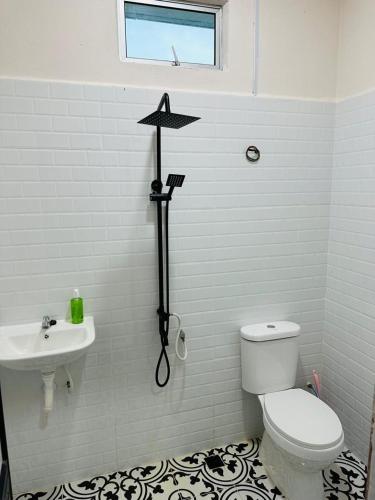 a bathroom with a toilet and a star on the wall at Triple S Homestay Bachok in Bachok