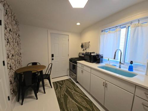 a kitchen with a table and a sink and a kitchen with a stove at Stylish Apt in Walker's Point in Milwaukee