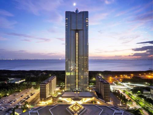 a tall building with lights on it at night at APA Hotel & Resort Tokyo Bay Makuhari in Chiba