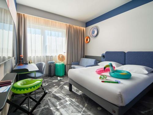 a bedroom with a bed with a swan on it at ibis Styles Katowice Airport in Pyrzowice