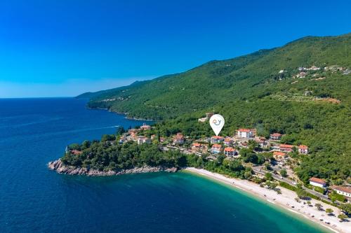 an aerial view of a small island in the ocean at Beachside Villa Mia Apartments in Medveja