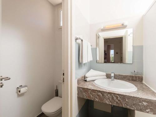 a bathroom with a sink and a toilet and a mirror at Lunja Village - Agadir in Taghazout