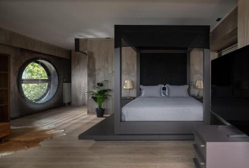 a bedroom with a large bed and a television at Luxury Villa Christina in Makrygialos