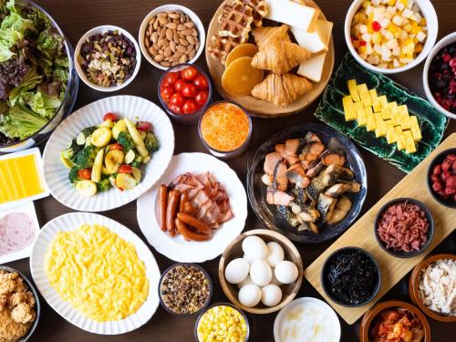 a table topped with plates of different types of food at Chisun Grand Takayama in Takayama