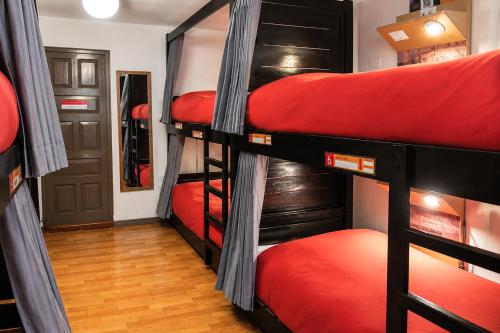 a group of bunk beds in a room at Pariwana Hostel Cusco in Cusco